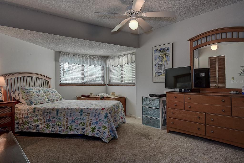 1500 Sunset Road, Unit G4 Tarpon Springs, FL 34689 - Photo 26 of 44 a bedroom with a bed a couch and dresser