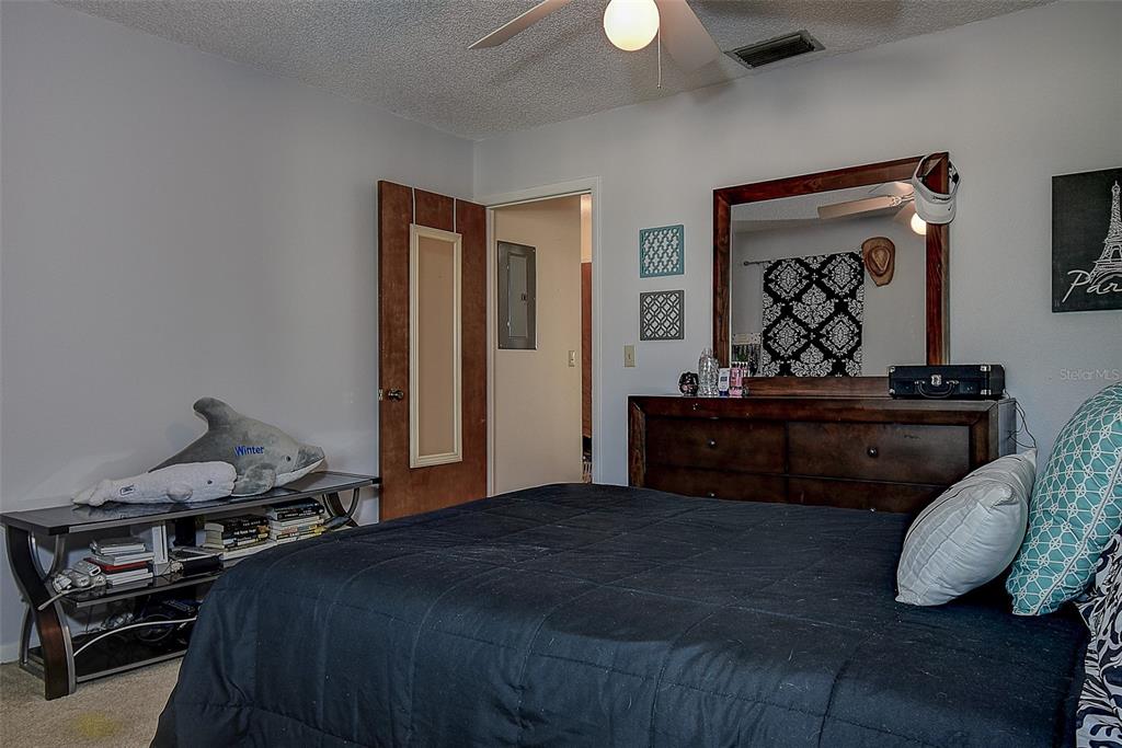 1500 Sunset Road, Unit G4 Tarpon Springs, FL 34689 - Photo 31 of 44 a bedroom with a bed and dresser