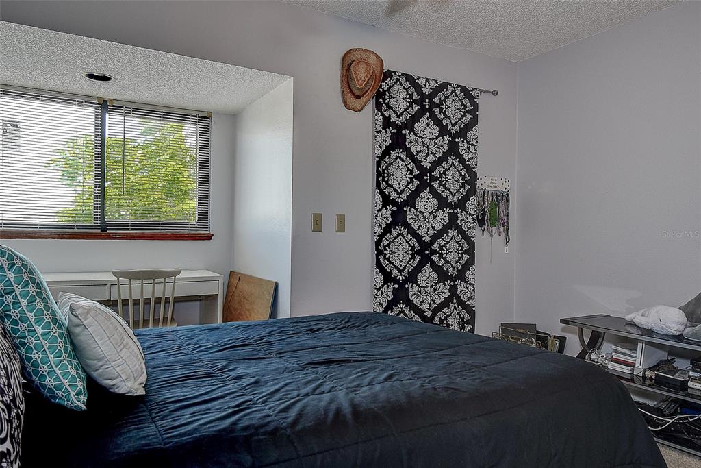1500 Sunset Road, Unit G4 Tarpon Springs, FL 34689 - Photo 32 of 44 a bedroom with a bed and a window