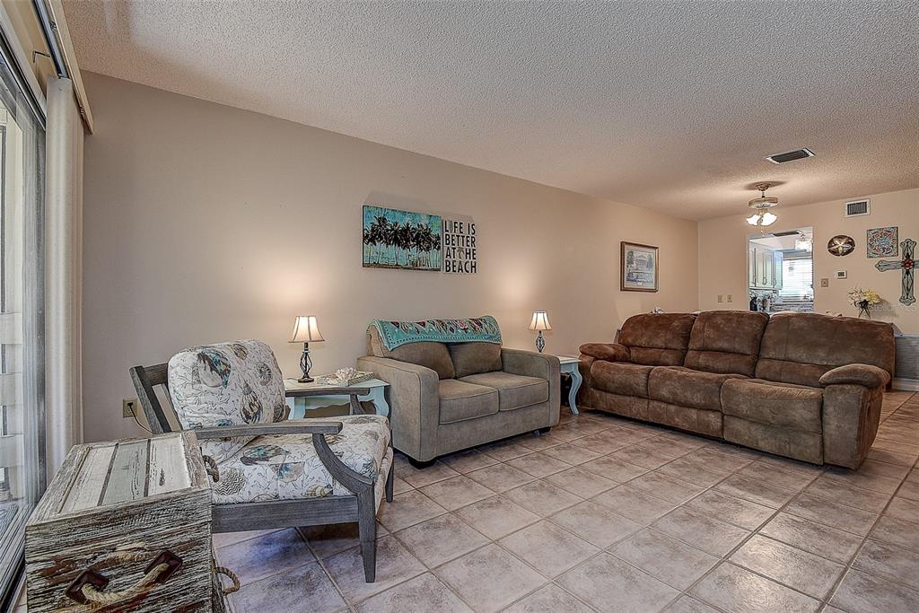 1500 Sunset Road, Unit G4 Tarpon Springs, FL 34689 - Photo 10 of 44 a living room with furniture and a flat screen tv