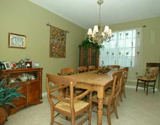 4459 Stone Ridge Way Weston, FL 33331 - Photo 3 of 8 a view of a dining room with furniture and chandelier