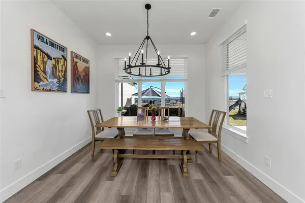 a living room with furniture a flat screen tv and a ceiling fan