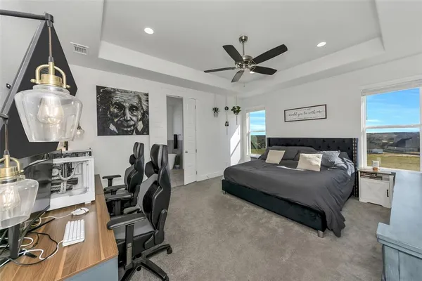 a bedroom that has a bed and a desk in it