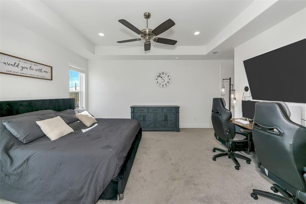 1040 Agnes Street North Springtown, TX 76082 - Photo 16 of 40 Bedroom featuring a tray ceiling, light carpet, a ceiling fan, recessed lighting, and a desk
