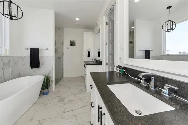 a white bath tub sitting next to a shower