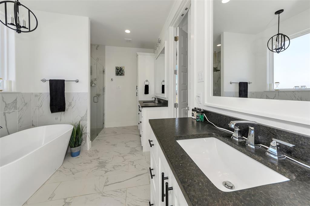 1040 Agnes Street North Springtown, TX 76082 - Photo 17 of 40 Bathroom featuring a chandelier, vanity, a stall shower, a soaking tub, and recessed lighting