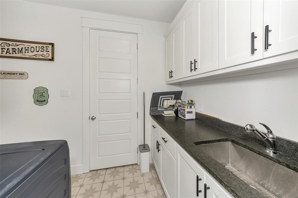 1040 Agnes Street North Springtown, TX 76082 - Photo 21 of 40 Laundry area featuring light floors, cabinet space, and washer / clothes dryer