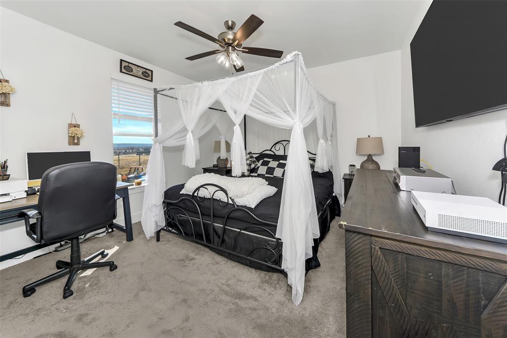 1040 Agnes Street North Springtown, TX 76082 - Photo 25 of 40 Carpeted bedroom with a desk and ceiling fan