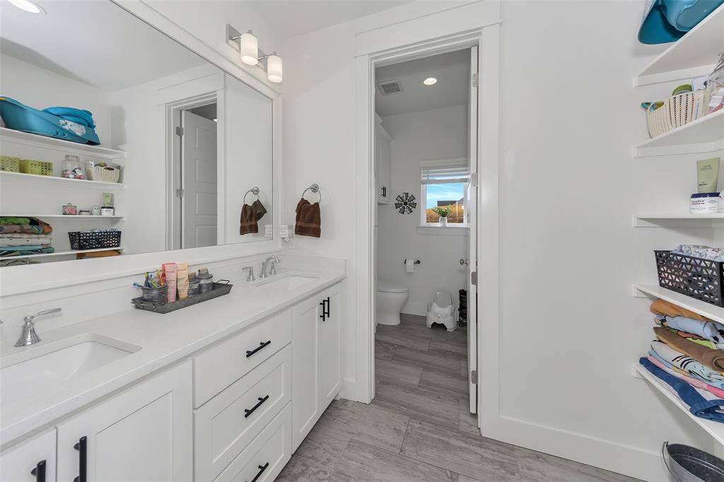 1040 Agnes Street North Springtown, TX 76082 - Photo 26 of 40 Full bathroom featuring double vanity and toilet