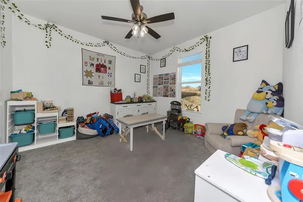 a bedroom with a bed and a chair in it