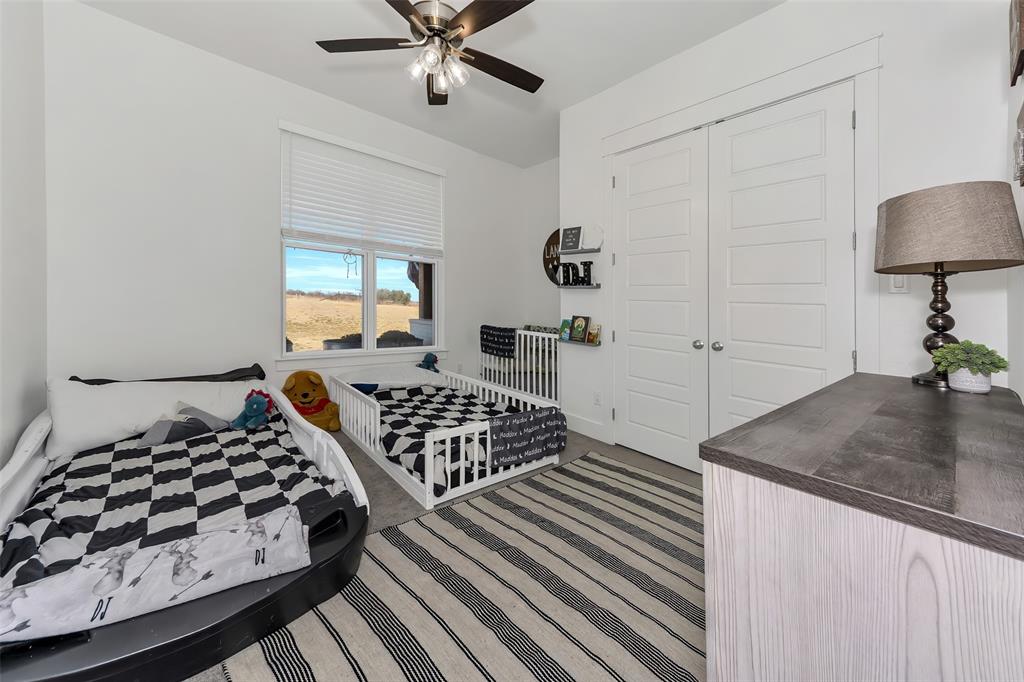 1040 Agnes Street North Springtown, TX 76082 - Photo 29 of 40 Bedroom with a closet, ceiling fan, and carpet floors