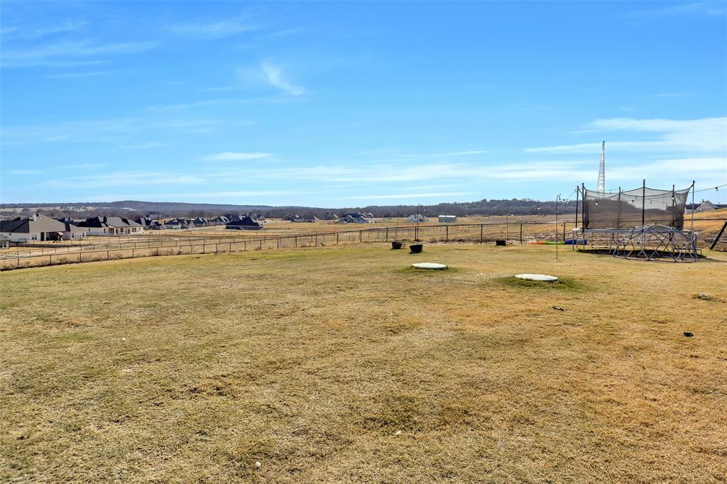 1040 Agnes Street North Springtown, TX 76082 - Photo 34 of 40 View of yard featuring a trampoline and a view of countryside