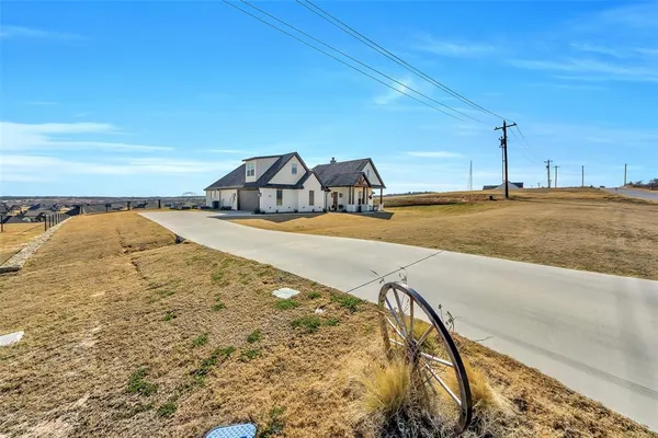a front view of a house with a garden and pathway