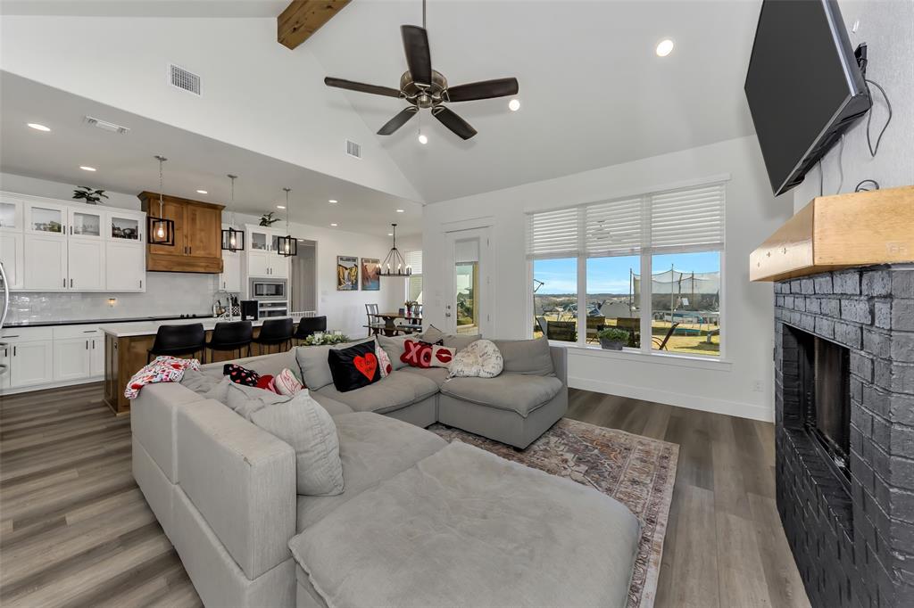1040 Agnes Street North Springtown, TX 76082 - Photo 4 of 40 Living room with recessed lighting, beamed ceiling, a fireplace, dark wood-type flooring, and high vaulted ceiling