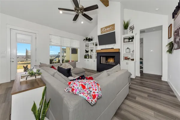 a living room with furniture fireplace and flat screen tv