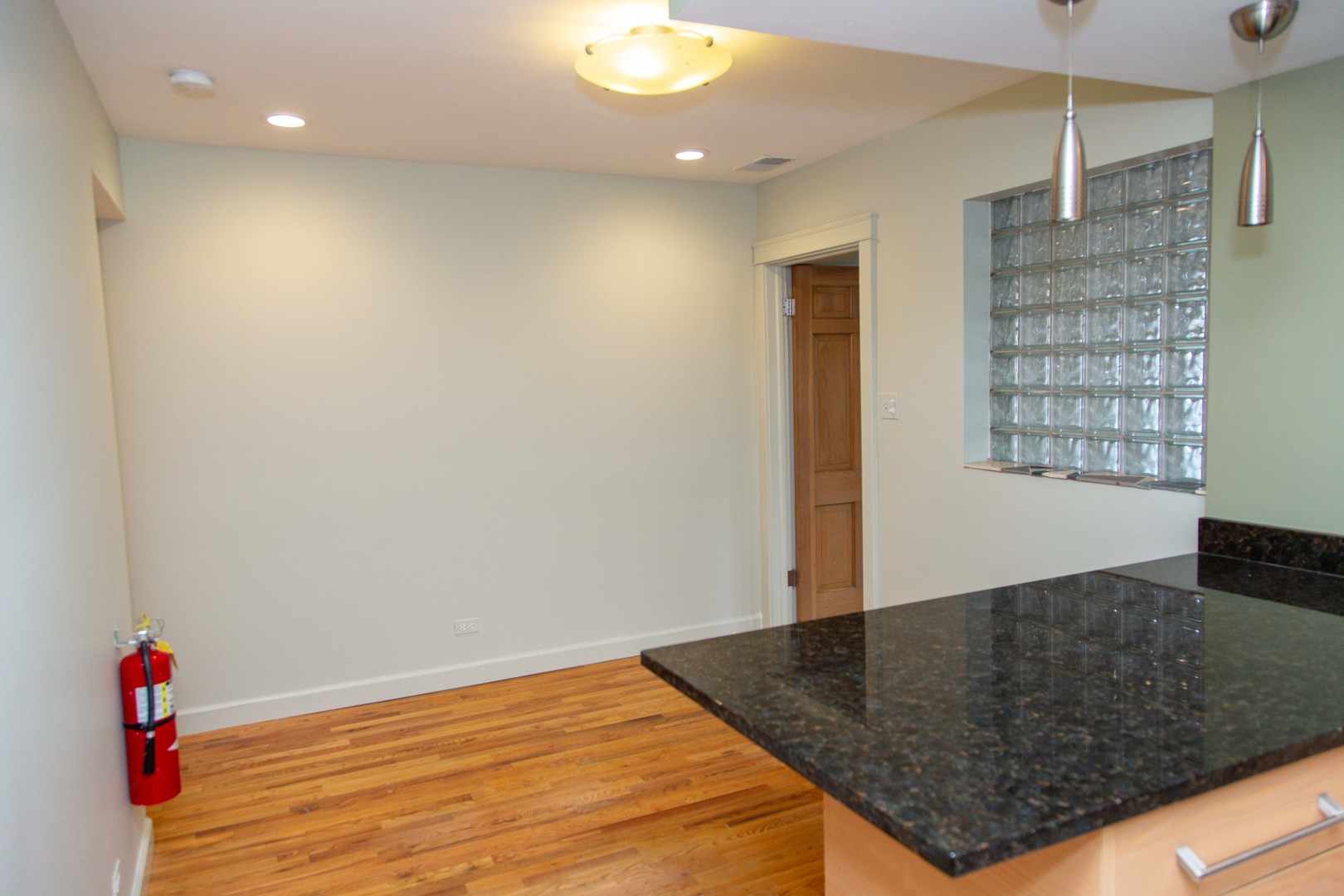 1607 Simpson Street, Unit 2E Evanston, IL 60201 - Photo 14 of 21 an empty room with wooden floor and cabinet