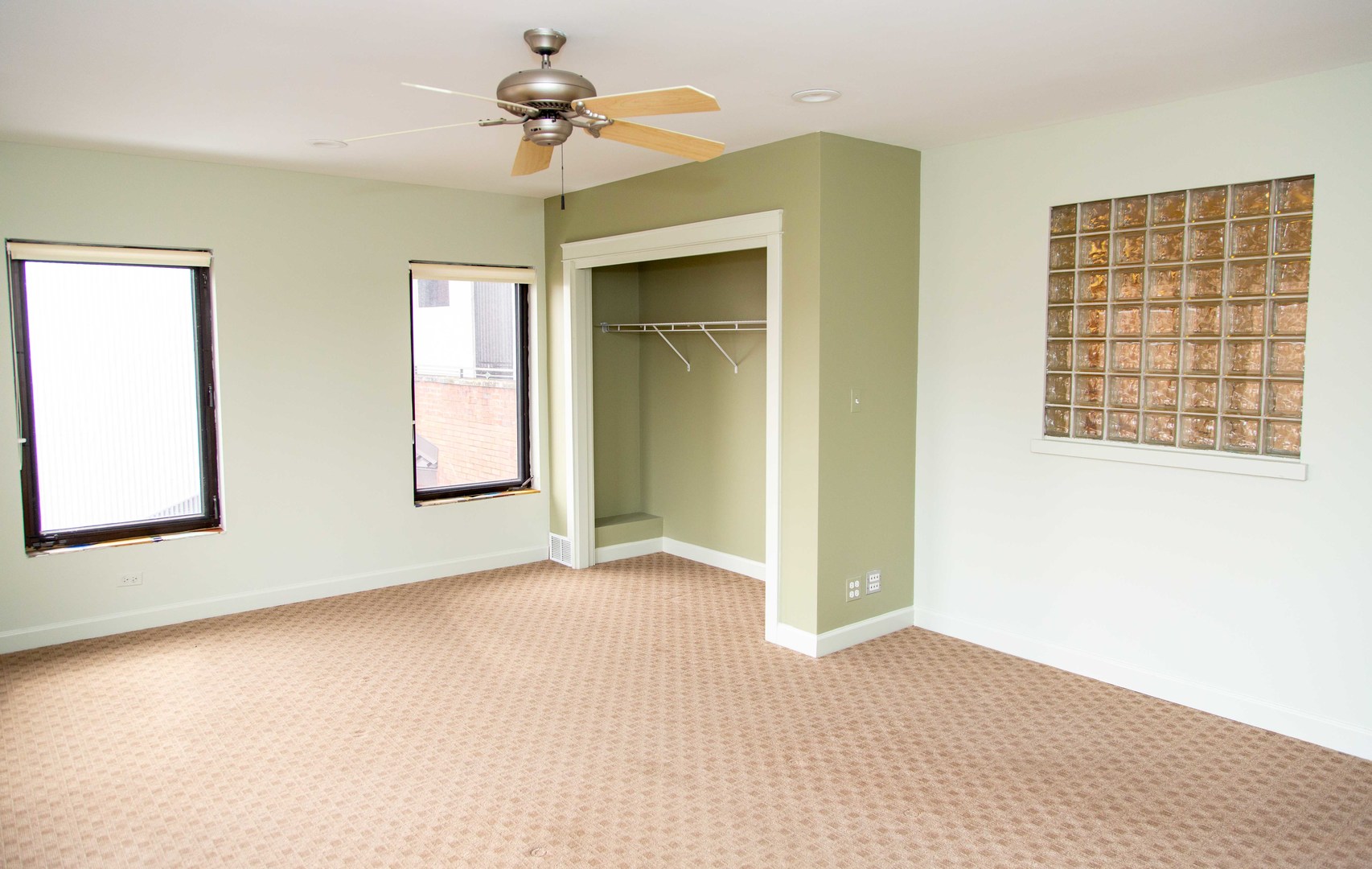 1607 Simpson Street, Unit 2E Evanston, IL 60201 - Photo 18 of 21 a view of an empty room with chandelier fan and windows