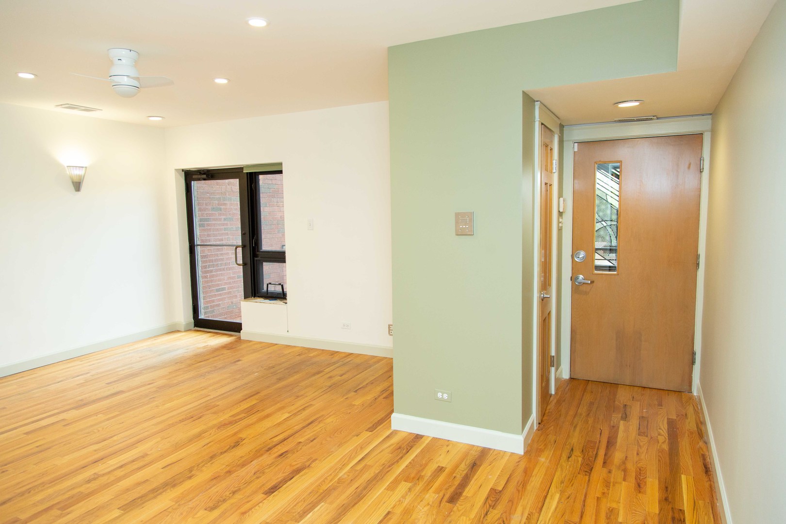 1607 Simpson Street, Unit 2E Evanston, IL 60201 - Photo 3 of 21 a view of an empty room with wooden floor and a bathroom