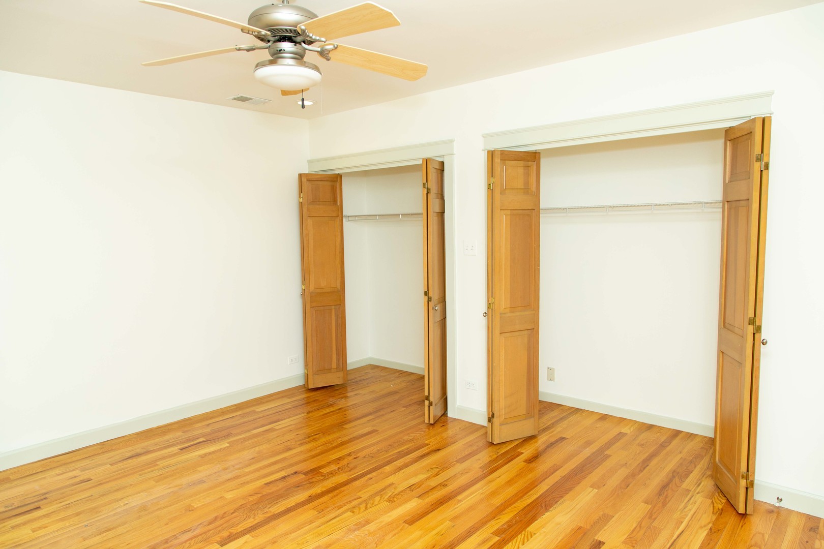1607 Simpson Street, Unit 2E Evanston, IL 60201 - Photo 8 of 21 a view of an empty room with wooden floor