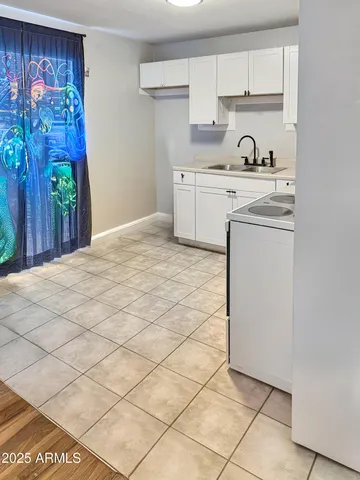 a kitchen with stainless steel appliances a stove a refrigerator and a cabinets