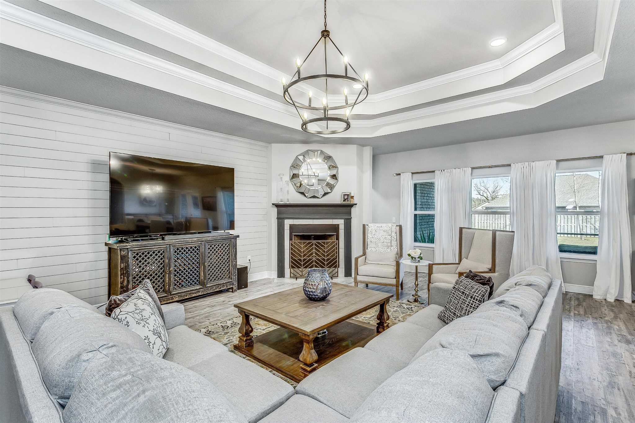 2792 Elkhorn Drive Pace, FL 32571 - Photo 12 of 50 a living room with furniture a flat screen tv and a chandelier