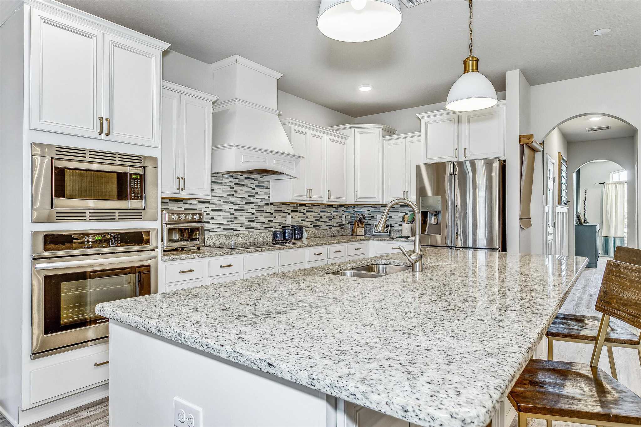 2792 Elkhorn Drive Pace, FL 32571 - Photo 18 of 50 a kitchen with stainless steel appliances granite countertop a sink stove and refrigerator