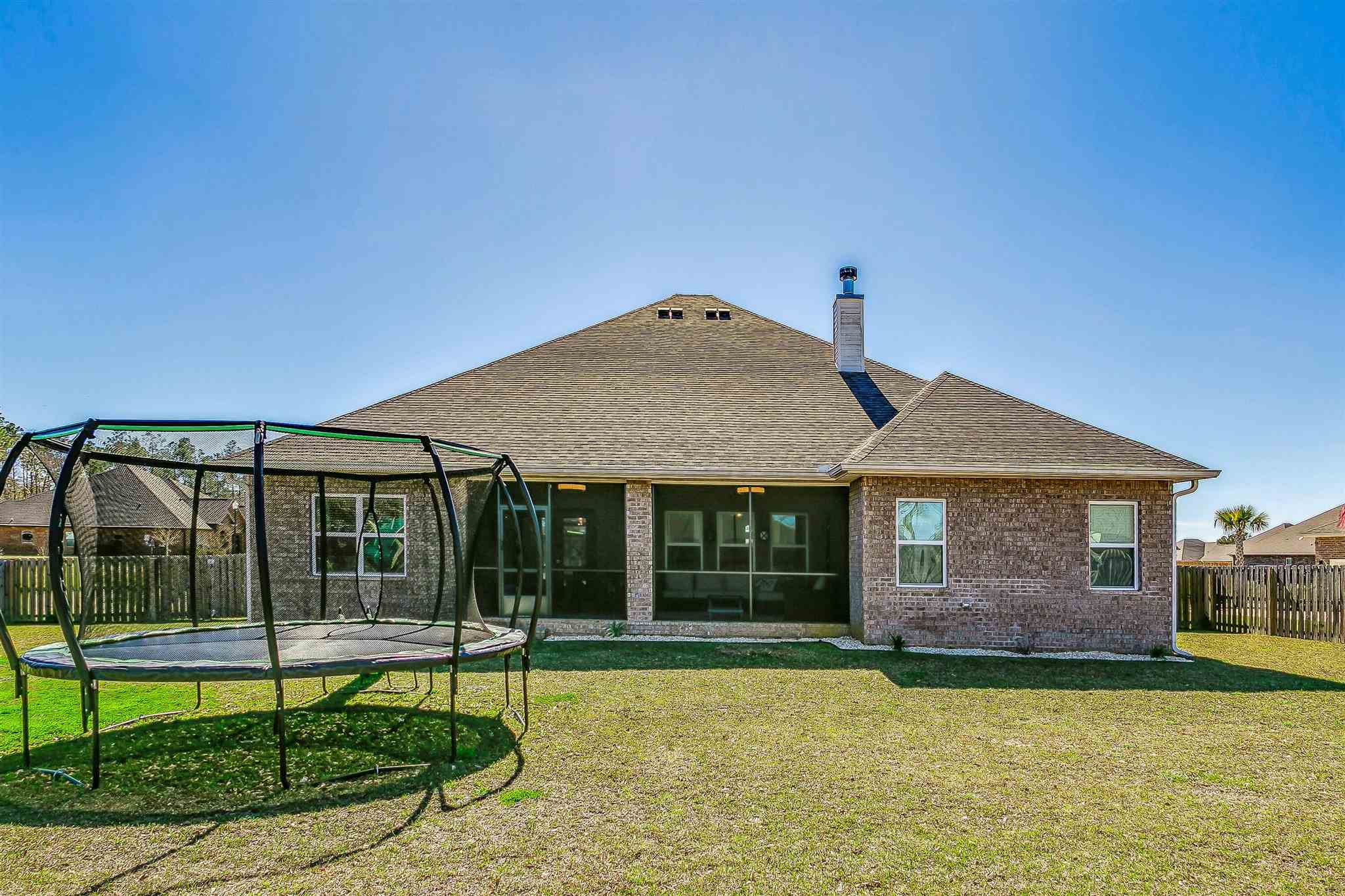 2792 Elkhorn Drive Pace, FL 32571 - Photo 46 of 50 a front view of a house with a garden