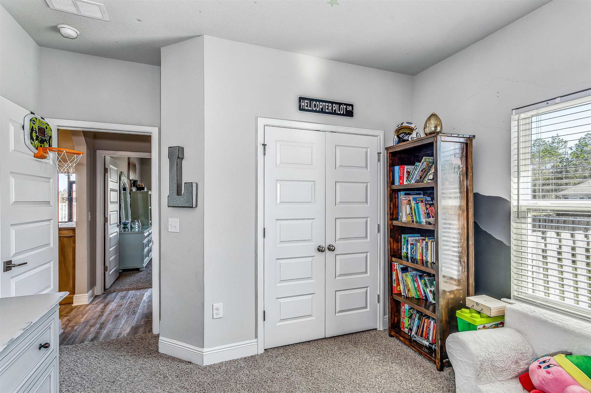 2792 Elkhorn Drive Pace, FL 32571 - Photo 10 of 50 a view of a bedroom with workspace and shelves