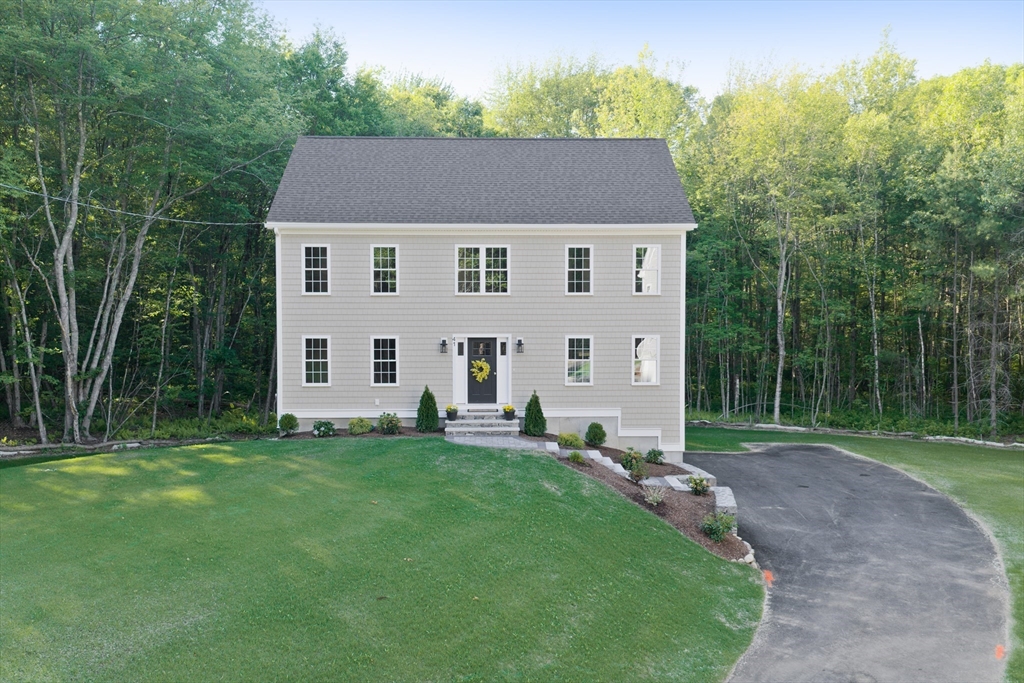 a aerial view of a house with a yard and a garden