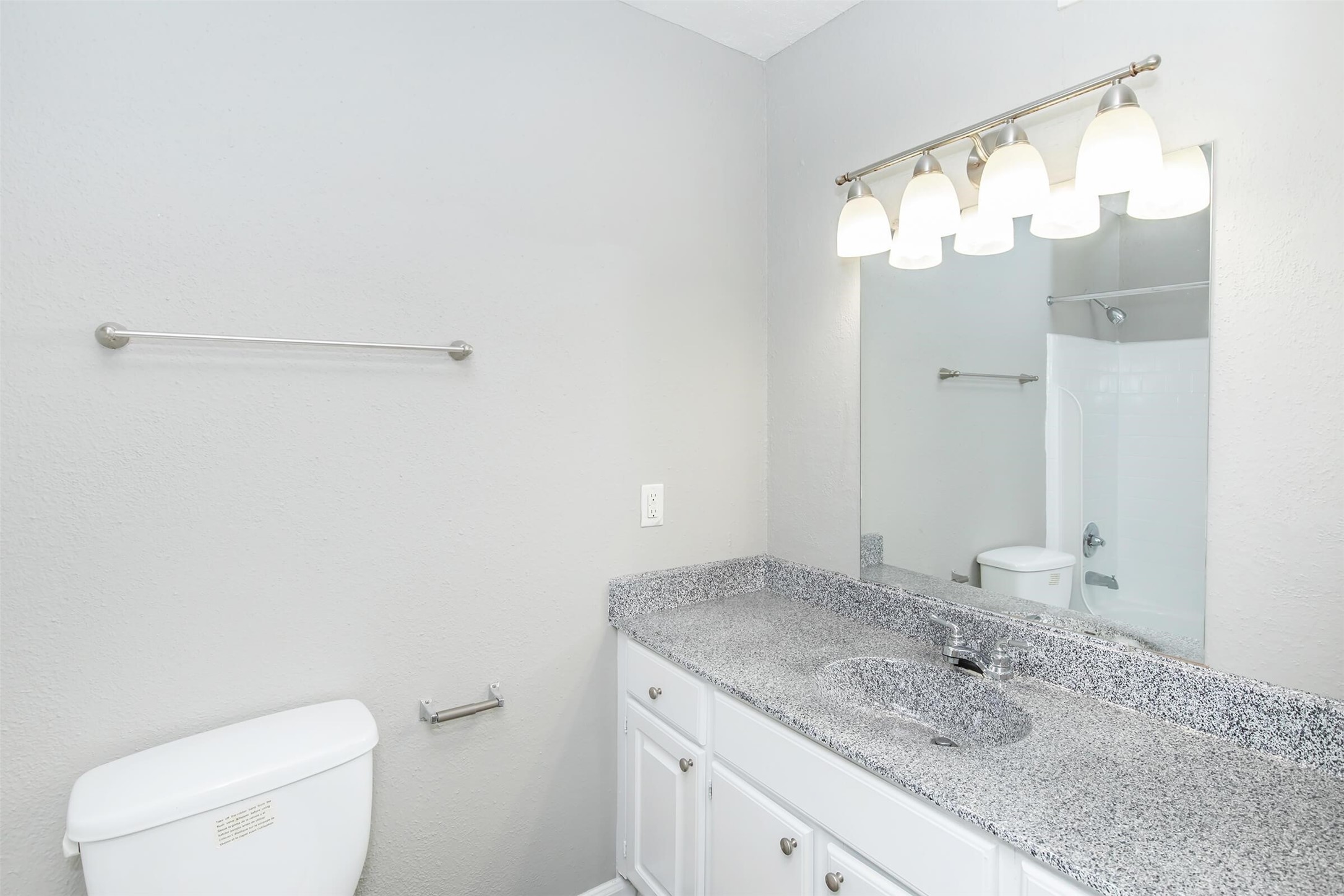18001 Cypress Trace Road, Unit 504 Houston, TX 77090 - Photo 12 of 34 a bathroom with a granite countertop sink mirror and toilet