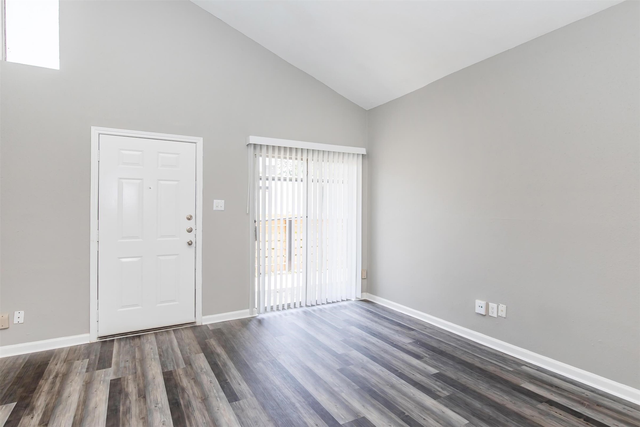 18001 Cypress Trace Road, Unit 504 Houston, TX 77090 - Photo 2 of 34 a view of an empty room with wooden floor and a window