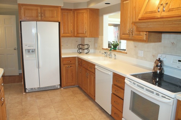 10 Longfellow Road Lexington, MA 02420 - Photo 11 of 29 a kitchen with a sink a refrigerator and cabinets