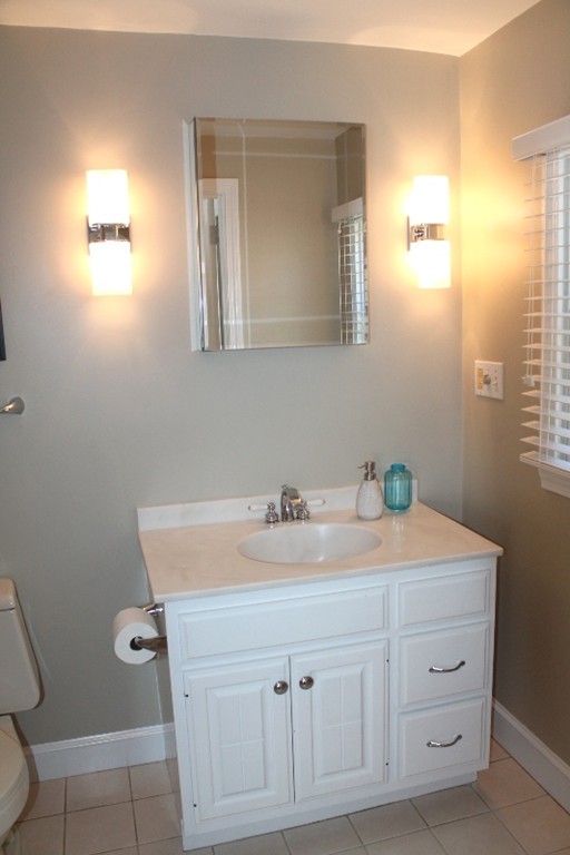 10 Longfellow Road Lexington, MA 02420 - Photo 14 of 29 a bathroom with a sink vanity and mirror
