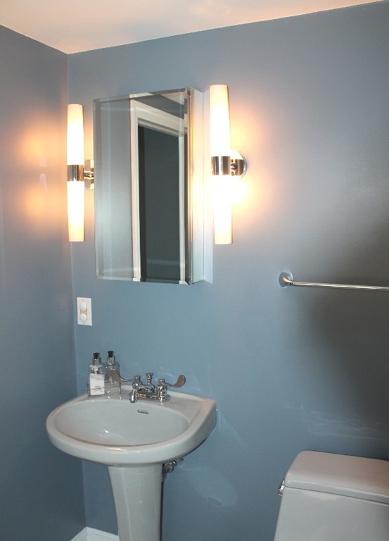 10 Longfellow Road Lexington, MA 02420 - Photo 16 of 29 a bathroom with a sink a mirror and a toilet