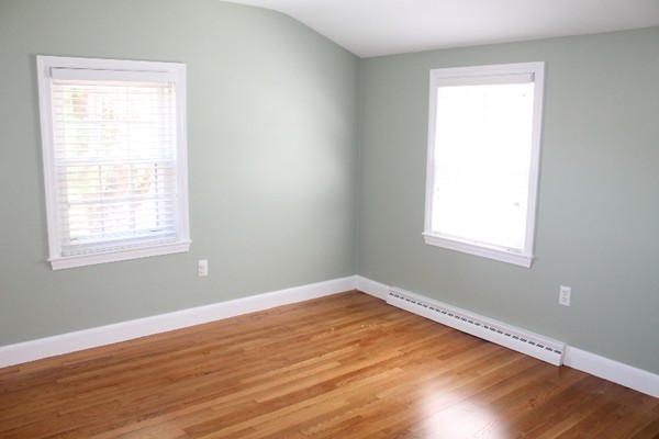10 Longfellow Road Lexington, MA 02420 - Photo 22 of 29 a view of an empty room with wooden floor and a window