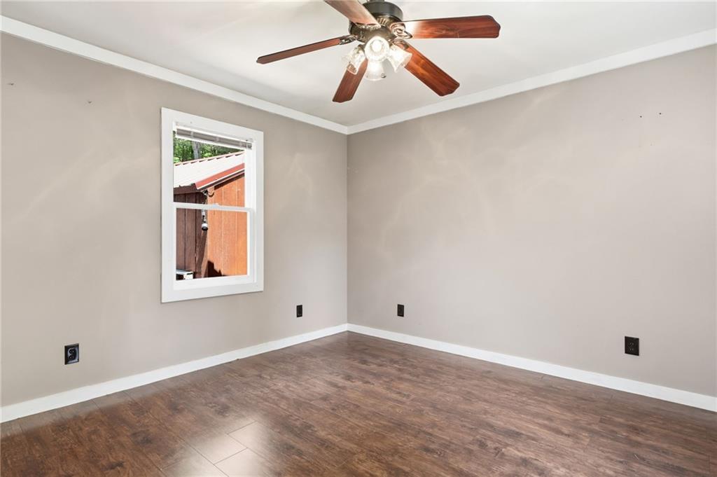 1709 Harrington Road Ball Ground, GA 30107 - Photo 16 of 46 an empty room with a window and a fan