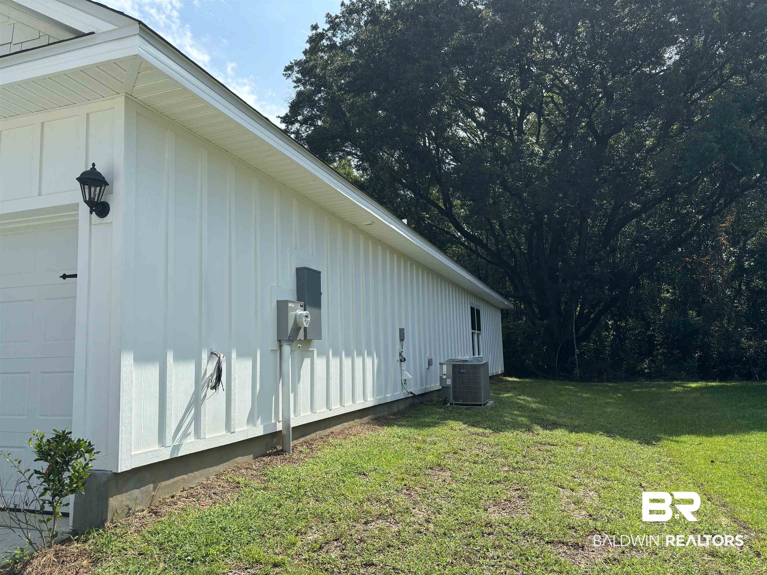 370 Barndling Street Fairhope, AL 36532 - Photo 4 of 30 View of side of home with a garage, cooling unit, and a lawn