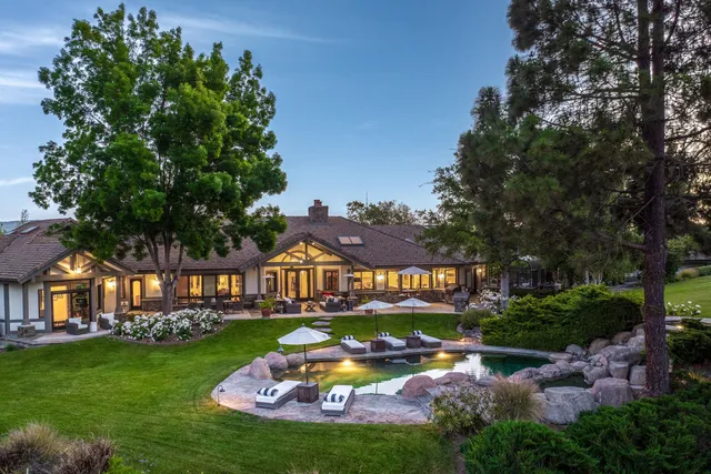 a view of swimming pool with outdoor seating and trees