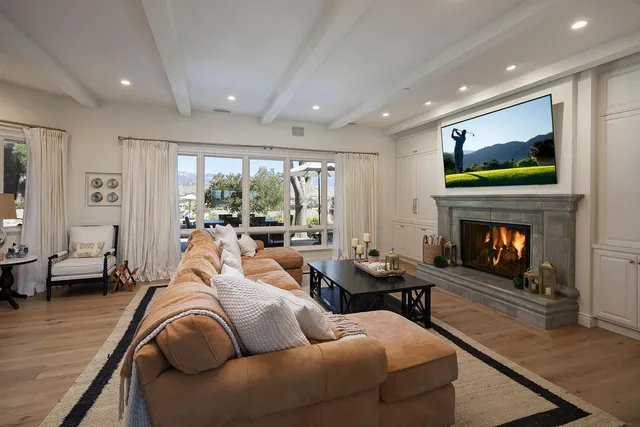 a living room with furniture fireplace and flat screen tv