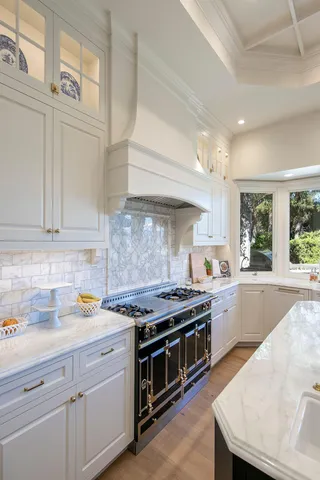 a kitchen with stainless steel appliances a stove a sink and cabinets