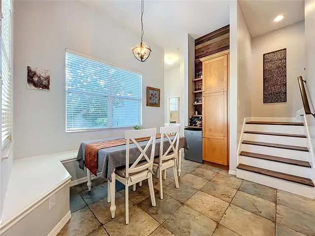 a large kitchen with stainless steel appliances kitchen island granite countertop a refrigerator and a stove