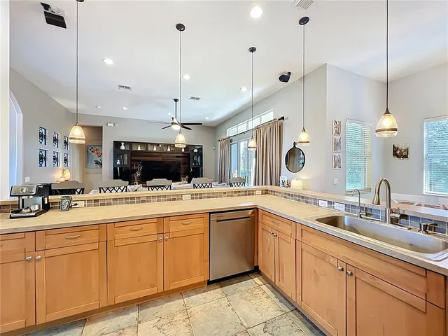 a kitchen with a refrigerator a oven and white cabinets