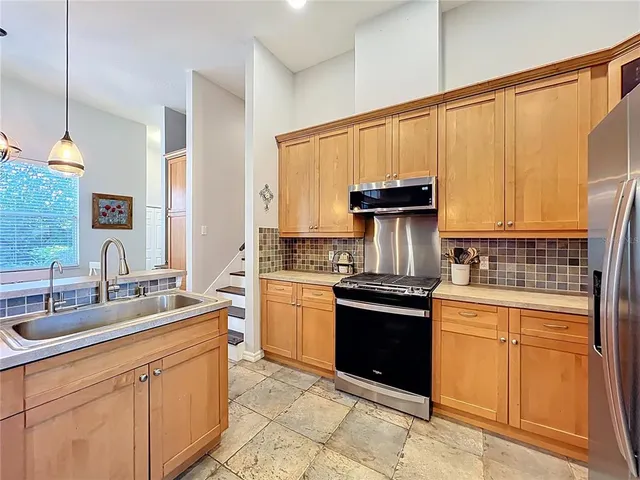a bedroom with bed a flat tv screen and a bookshelf