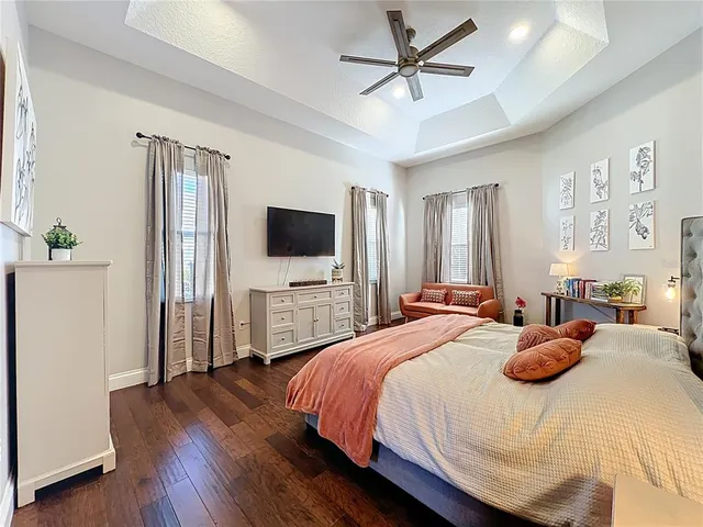 a bathroom with a tub a double vanity sink and mirror