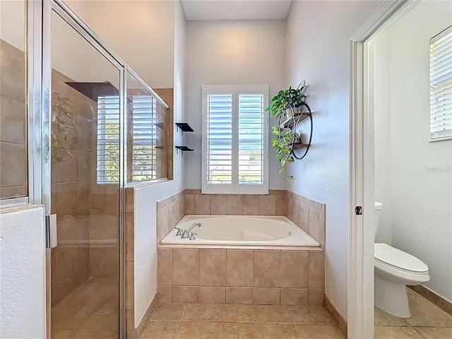 a room with furniture a flat screen tv and a table