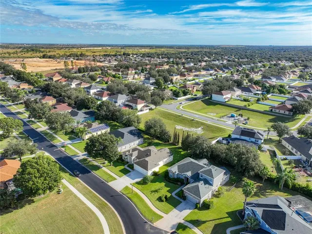 an aerial view of residential houses with outdoor space
