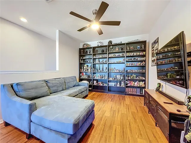 a living room with furniture a rug and a large window