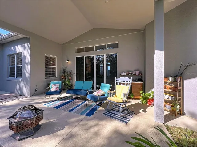 a view of a swimming pool with a yard and trees in the background