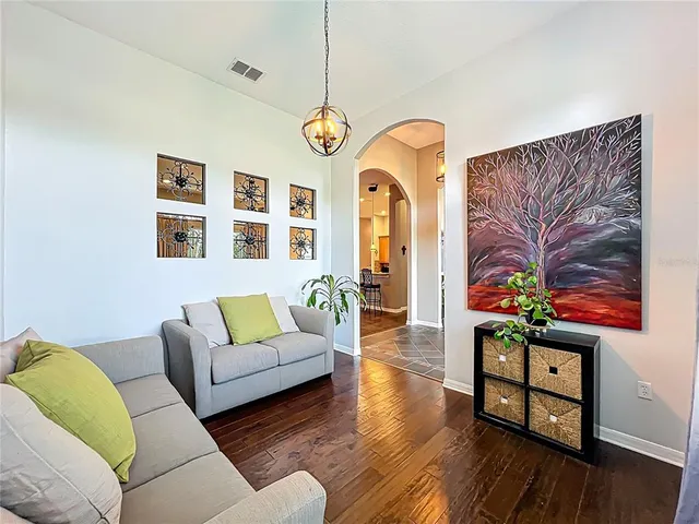 a living room with fireplace furniture and wooden floor