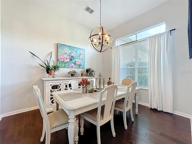 a view of a dining room with furniture wooden floor and a chandelier